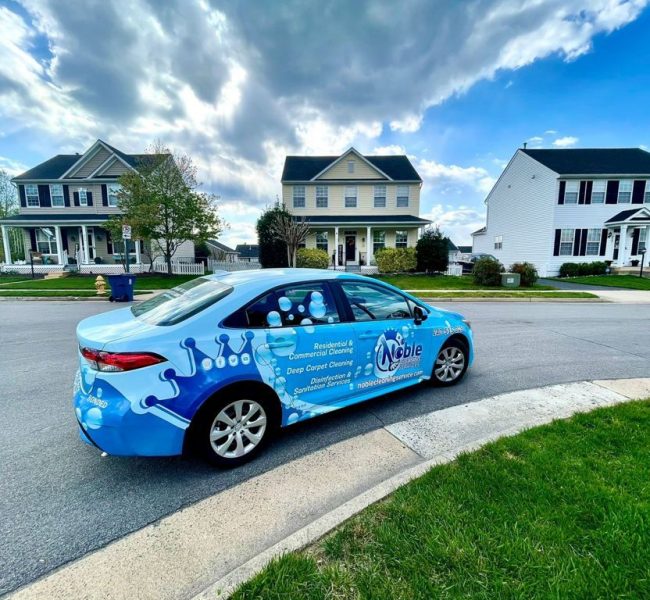 Noble Cleaning Services Branded Car in Residential Neighborhood
